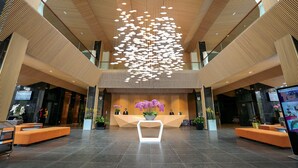 A spacious lobby with a modern ceiling design, a reception desk, and seating areas. - Terracotta Hotel & Resort Dalat (Xuan Huong - Da Lat)