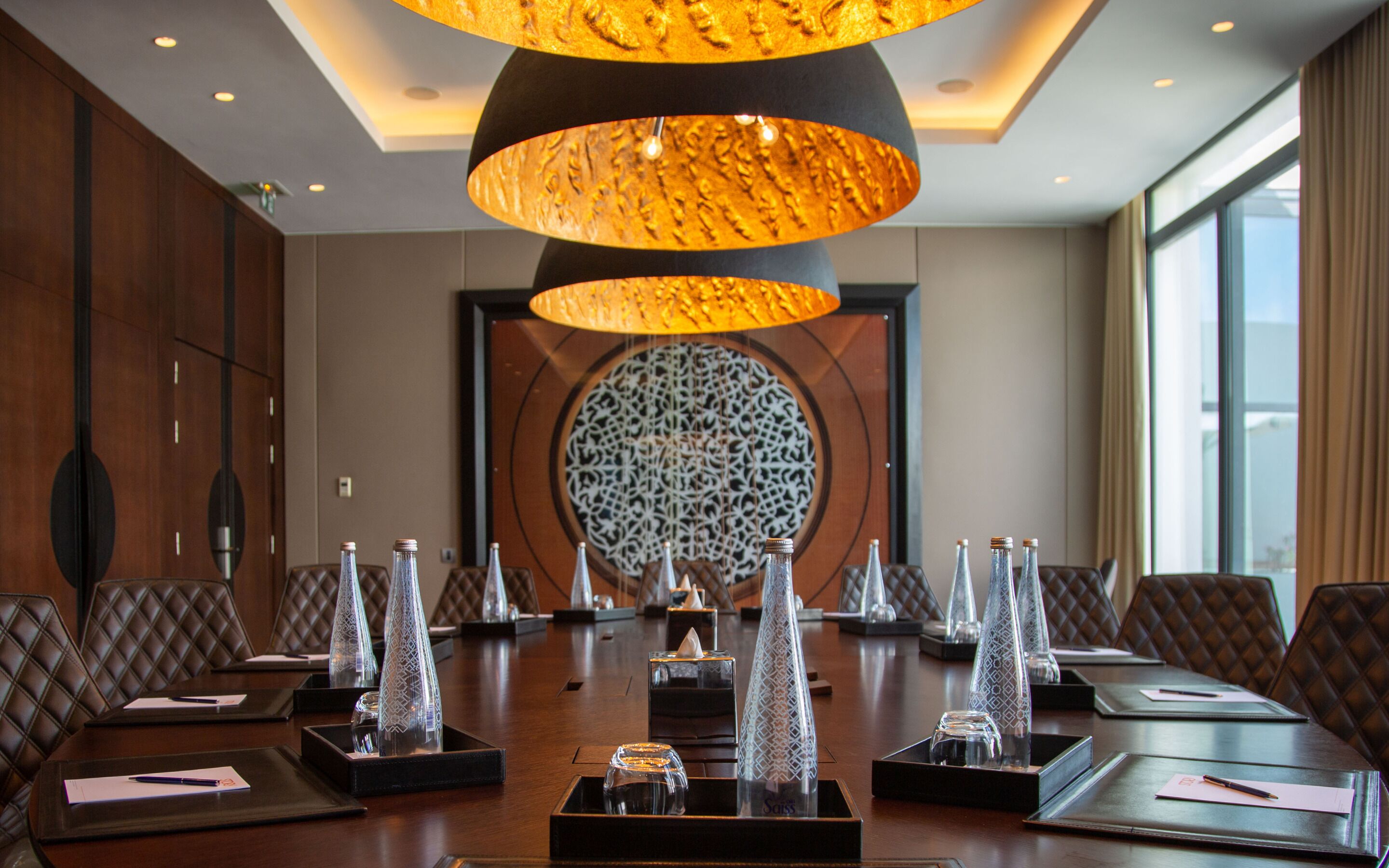 A conference room with a large table, chairs, and decorative glass vases.
