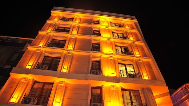 A multi-story building with illuminated balconies and windows at night. - Comfort Elite Hotels Old City (Istanbul)