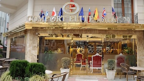 The exterior of Comfort Elite Hotels with multiple flags, a grand entrance, and outdoor seating. - Comfort Elite Hotels Old City (Istanbul)