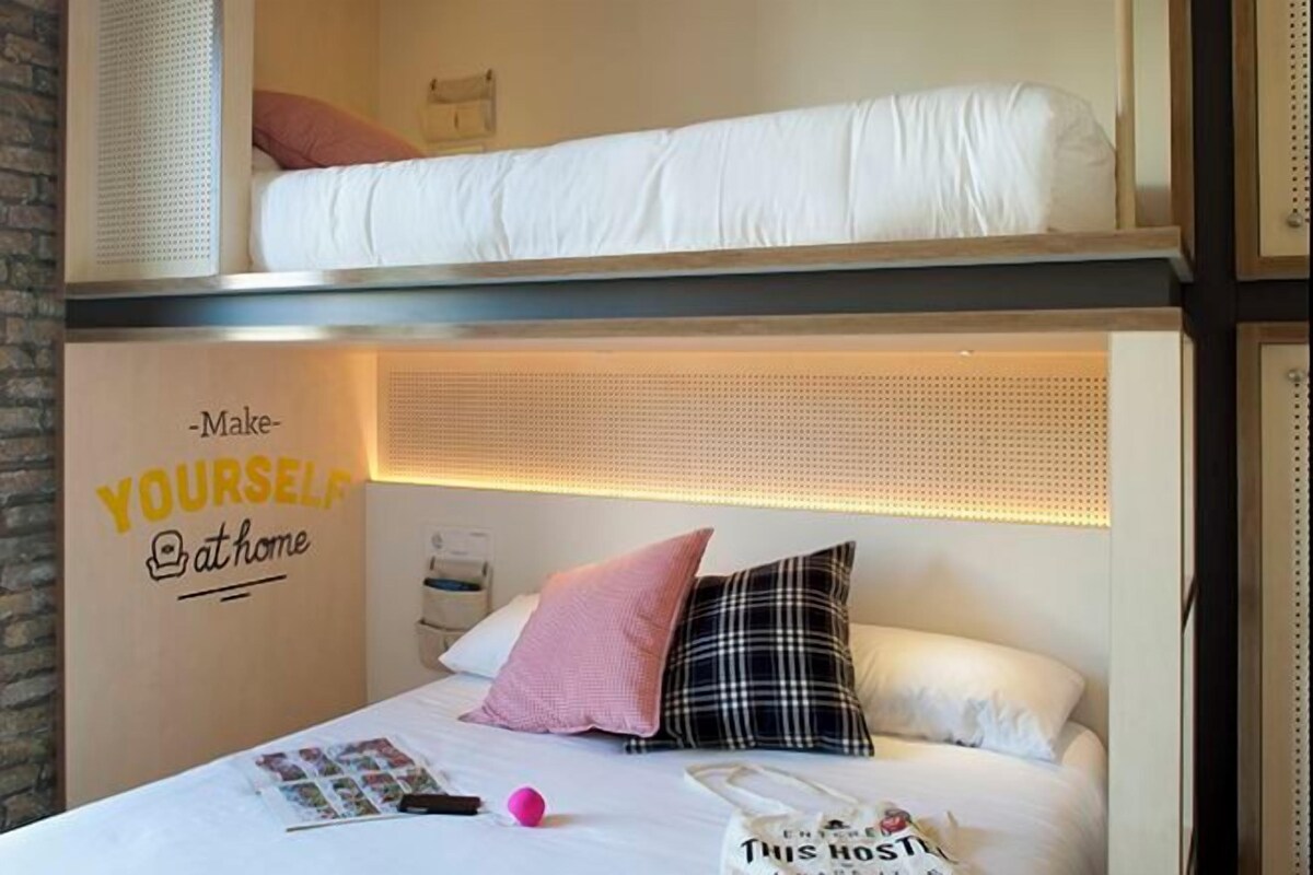 A bunk bed room with a headboard that has a motivational quote.