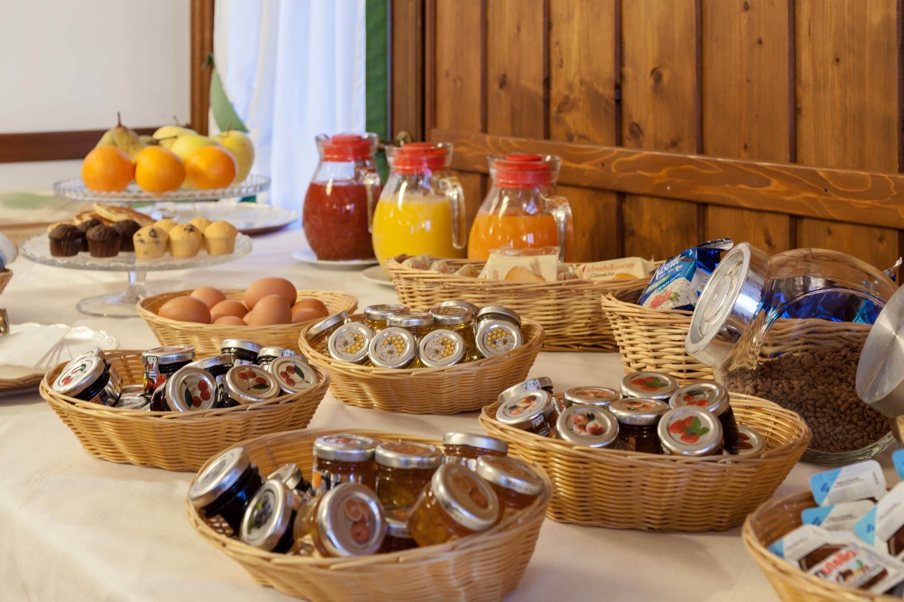 A breakfast buffet with various food items and condiments.