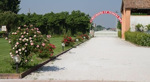 A pathway leading to a building with a red archway.