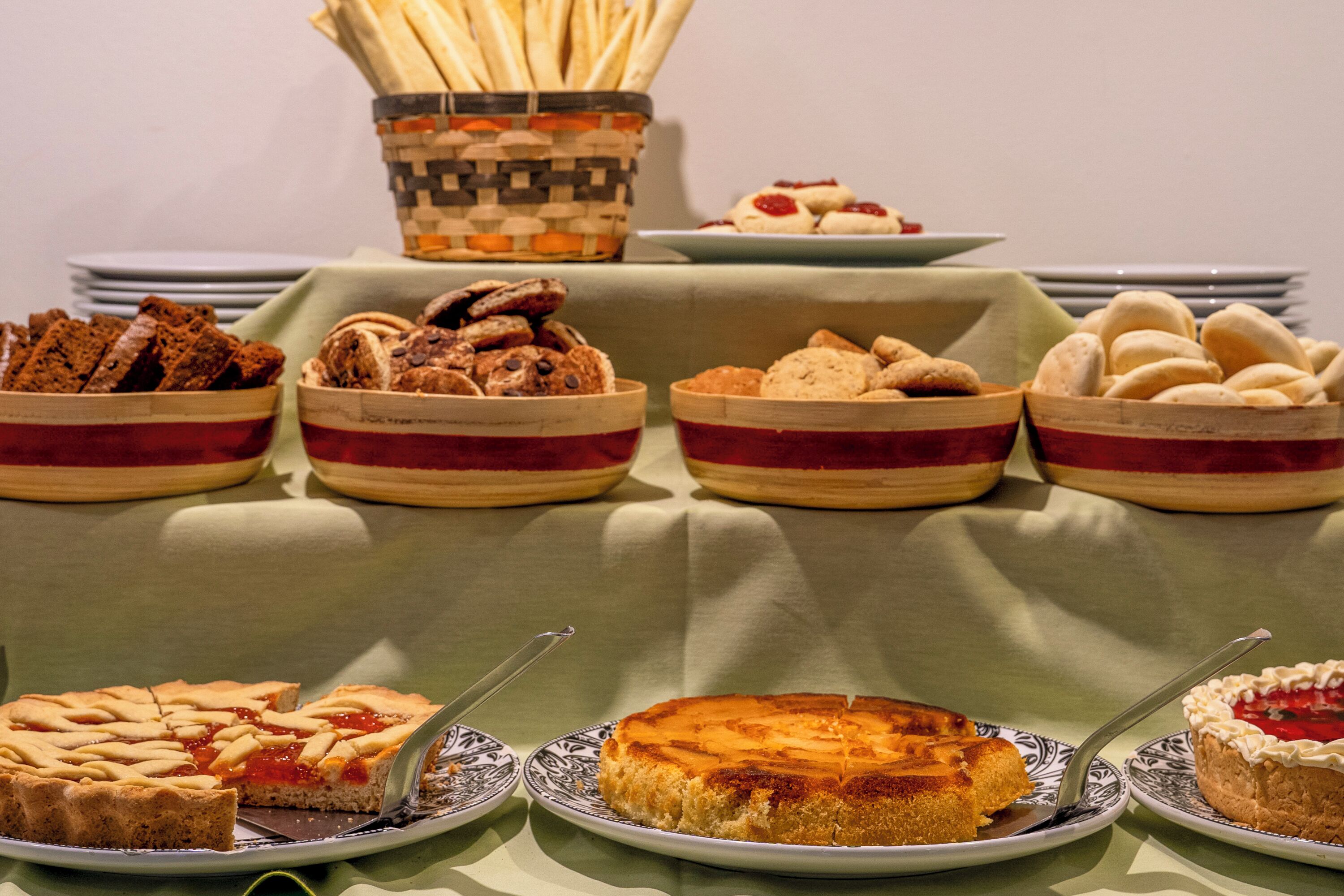 A buffet table with various baked goods and desserts.