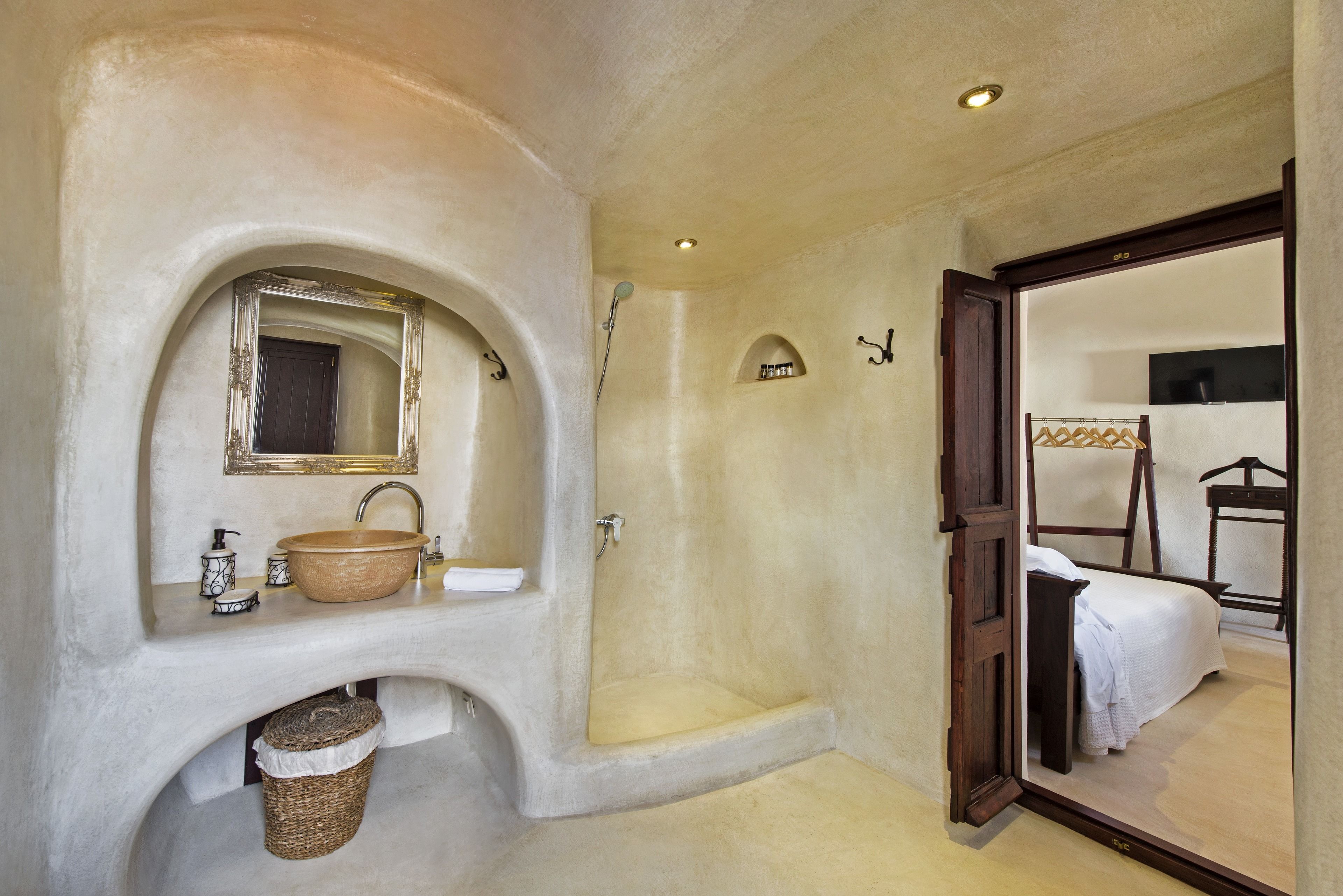 A bathroom with a large sink, mirror, and shower.