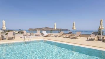 Seasonal outdoor pool, an infinity pool, pool umbrellas, pool loungers