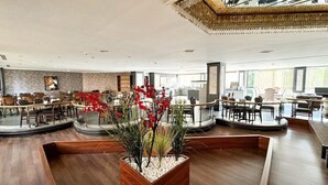 A spacious lobby with a central seating area, a large chandelier, and a view of the city through large windows. - Aldino Hotel & Spa (Ankara)
