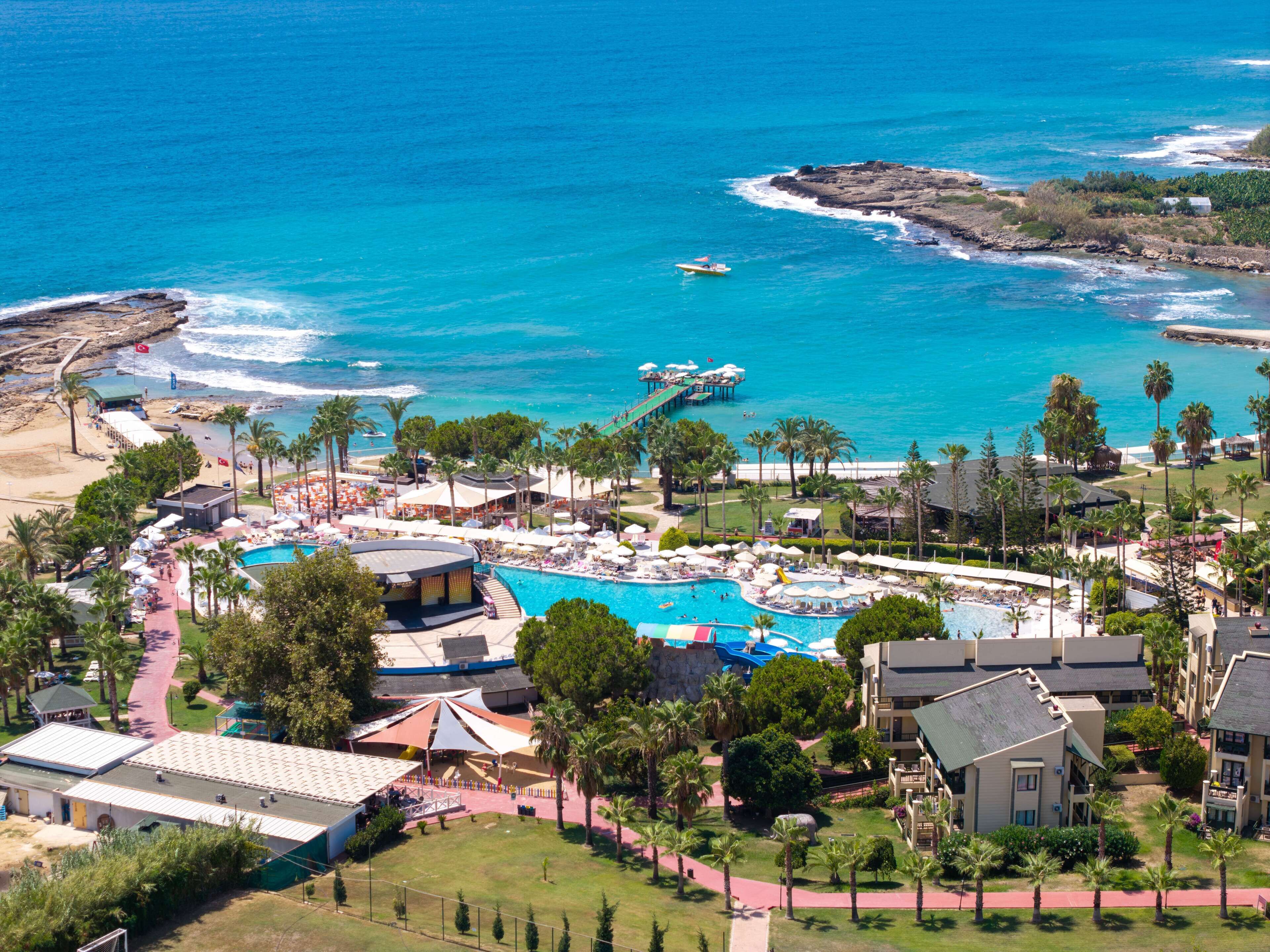 A resort with a large pool, beach access, and ocean views.