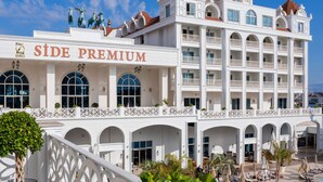A hotel with a prominent 'SIDE PREMIUM' sign, multiple balconies, and a pool area. - Oz Hotels Side Premium (Manavgat)
