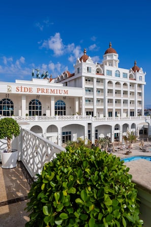 A hotel with a prominent 'SIDE PREMIUM' sign, multiple balconies, and a pool area. - Oz Hotels Side Premium (Manavgat)