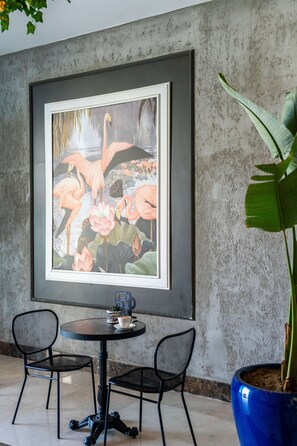 A framed painting of flamingos and lotus flowers on a textured wall. - Oz Hotels Side Premium (Manavgat)