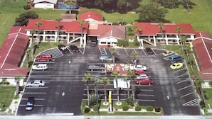 A multi-story parking garage with a red roof and multiple levels of parking. - Orange City Motel (Orange City)