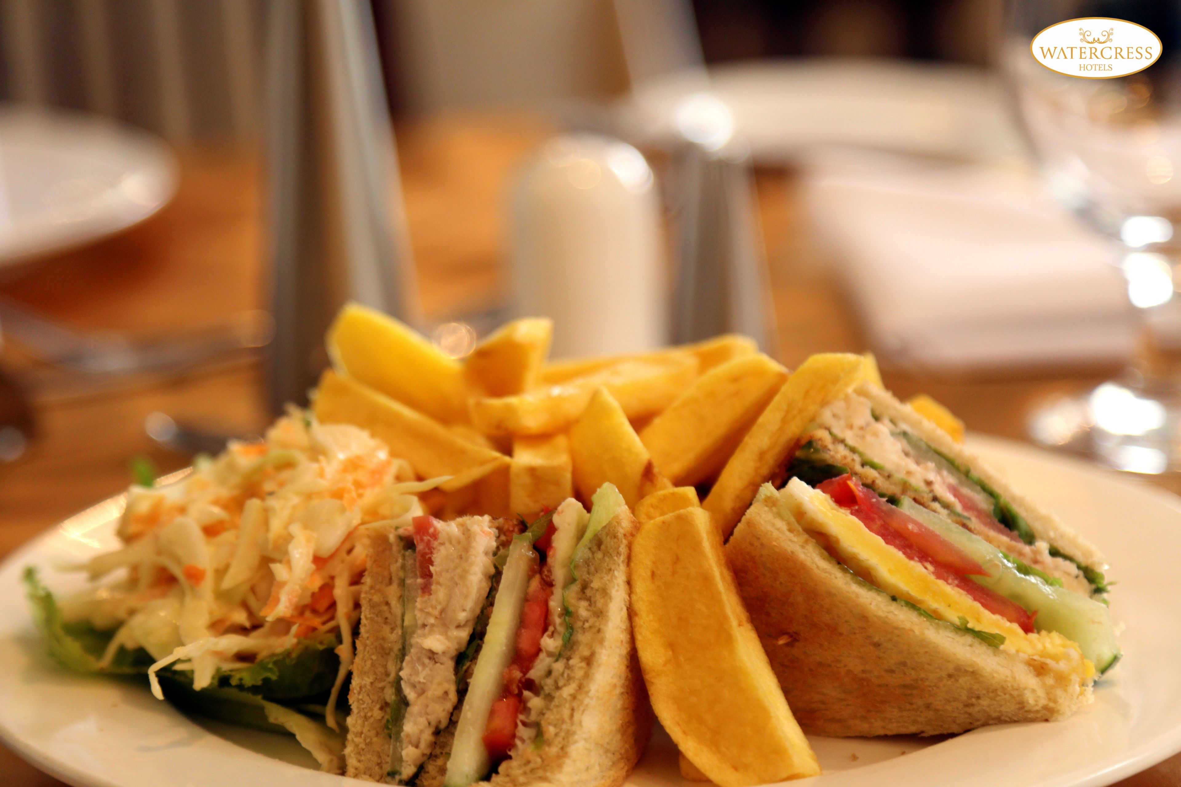 A plate with a sandwich and fries.