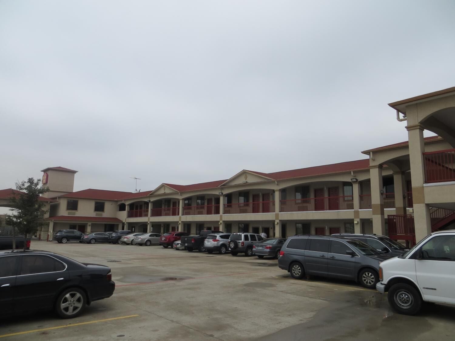 A multi-story hotel with a parking lot.