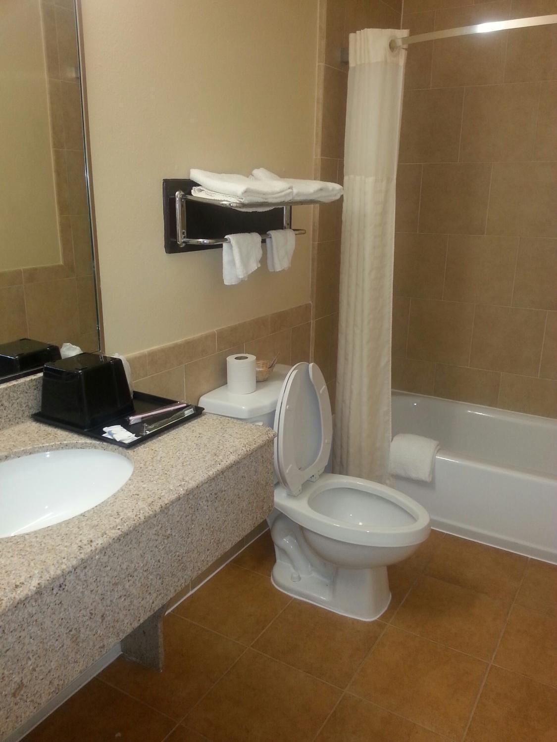 A bathroom with a sink, toilet, and bathtub.