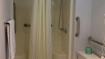 A bathroom with a shower, toilet, and sink.