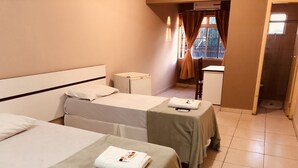 A hotel room with two beds, a nightstand, a desk, and a window with curtains. - Dok Brasília Hotel - Unidade Taguatinga (Águas Claras)