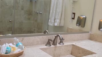 A bathroom with a sink, mirror, and a towel rack.
