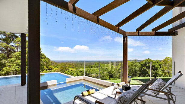A rooftop infinity pool with lounge chairs, a pergola, and a scenic view of the landscape. - Alexandria Retreat (Doonan)