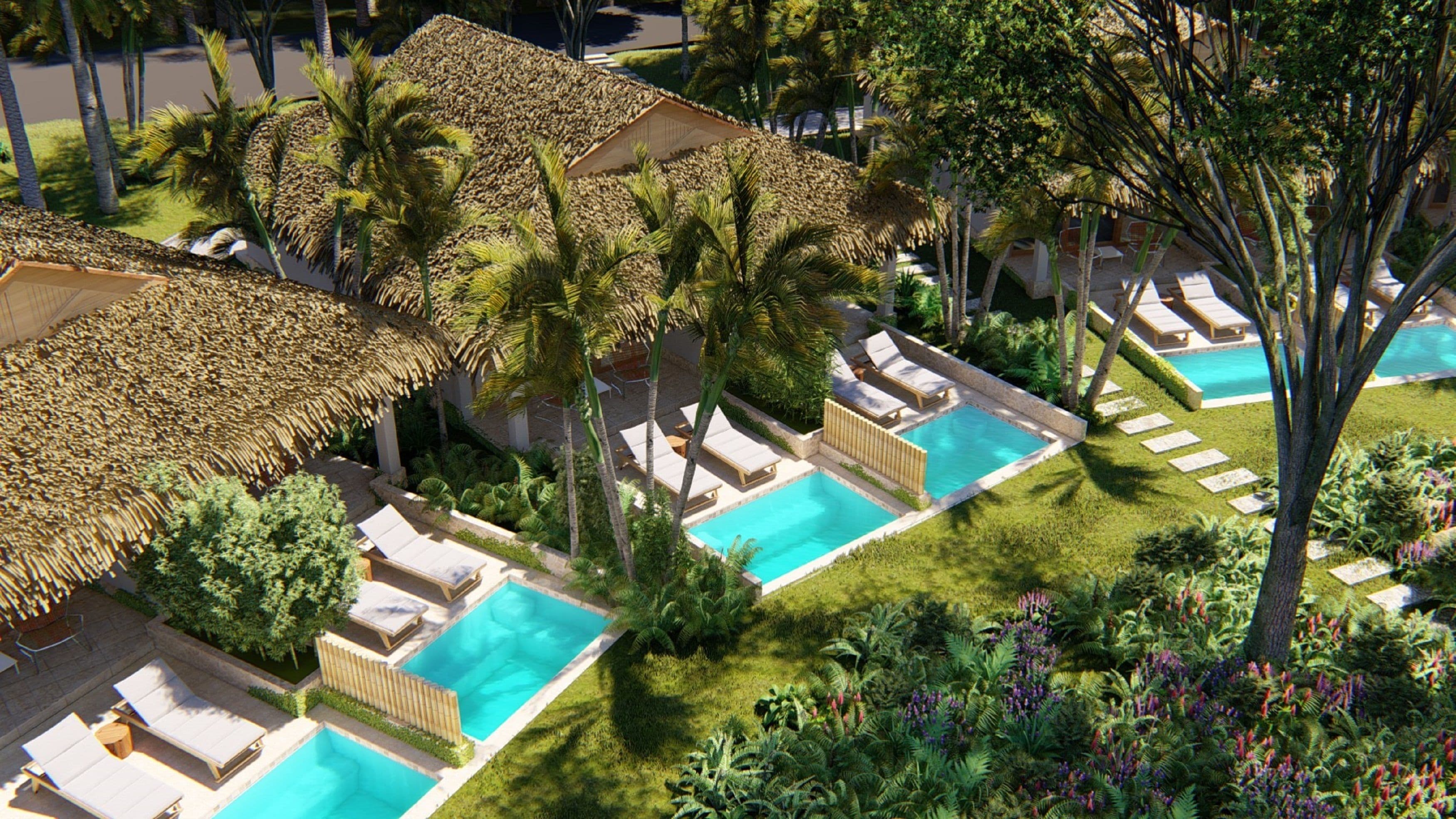 A resort with multiple swimming pools, lounge areas, and palm trees.