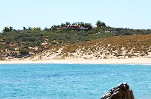 On the beach, white sand, beach umbrellas, beach towels