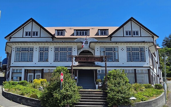 A two-story building with a sign reading 'HOTEL RODMAY' at the entrance. - Rodmay Heritage Hotel (Powell River)