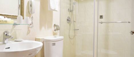 A modern bathroom with a glass-enclosed shower, a white sink, and a toilet.