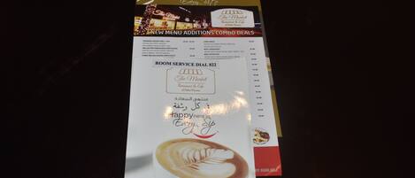 A menu with new combo deals and a room service number.