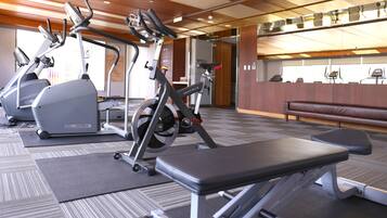 A gym with treadmills, elliptical machines, and weight equipment.