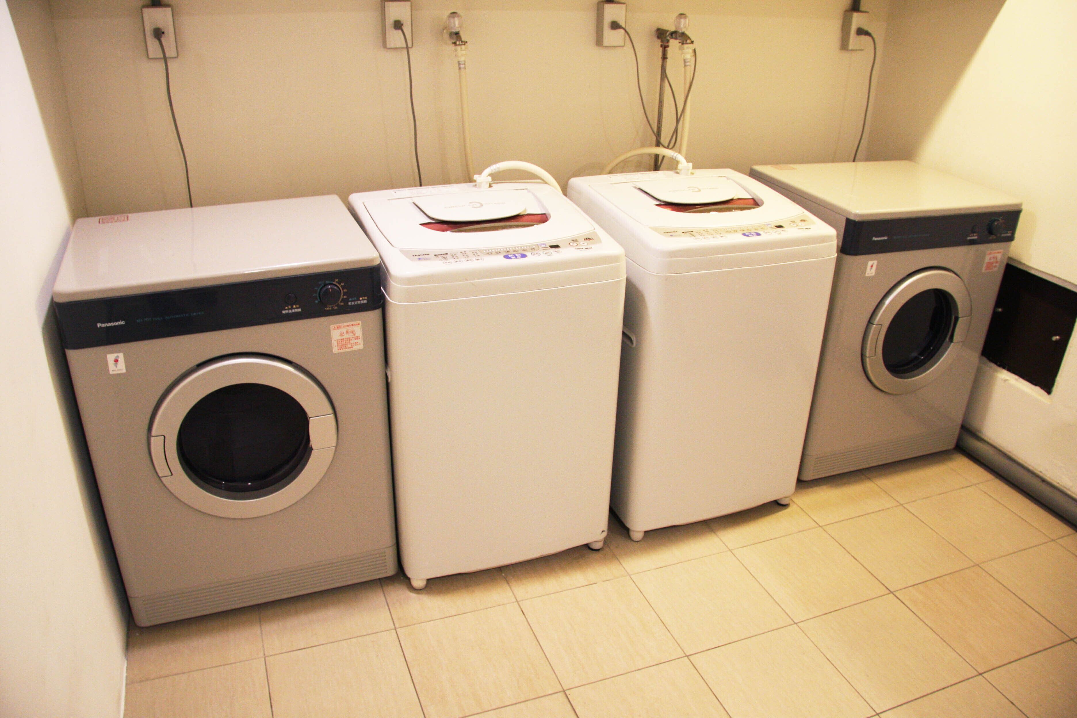 A laundry area with three stacked washing machines.