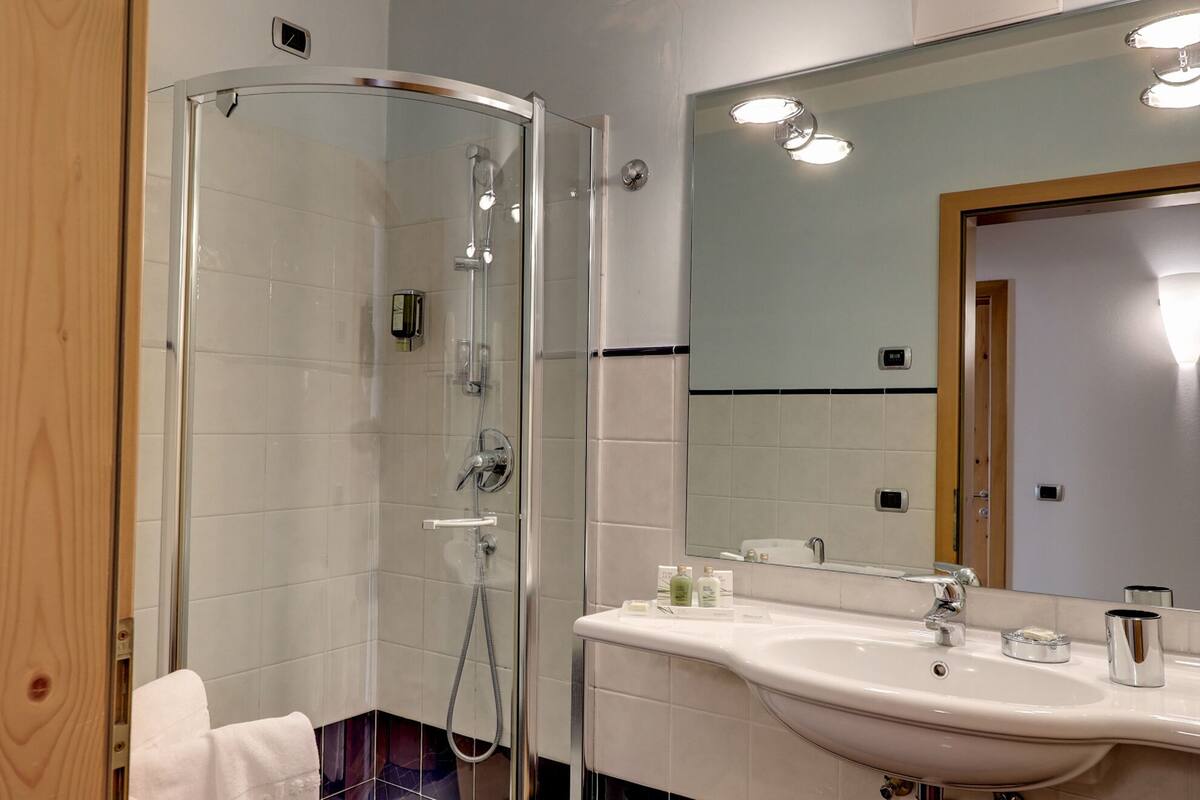 junior suite | bathroom | shower, designer toiletries, hair dryer, slippers