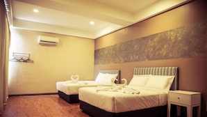 A hotel room with two beds, a small bedside table, and a wall-mounted air conditioner. - Bangi Gateway Hotel (Bandar Baru Bangi)