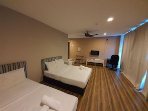A hotel room with two beds, a desk, a chair, a television, and a ceiling fan. - Bangi Gateway Hotel (Bandar Baru Bangi)
