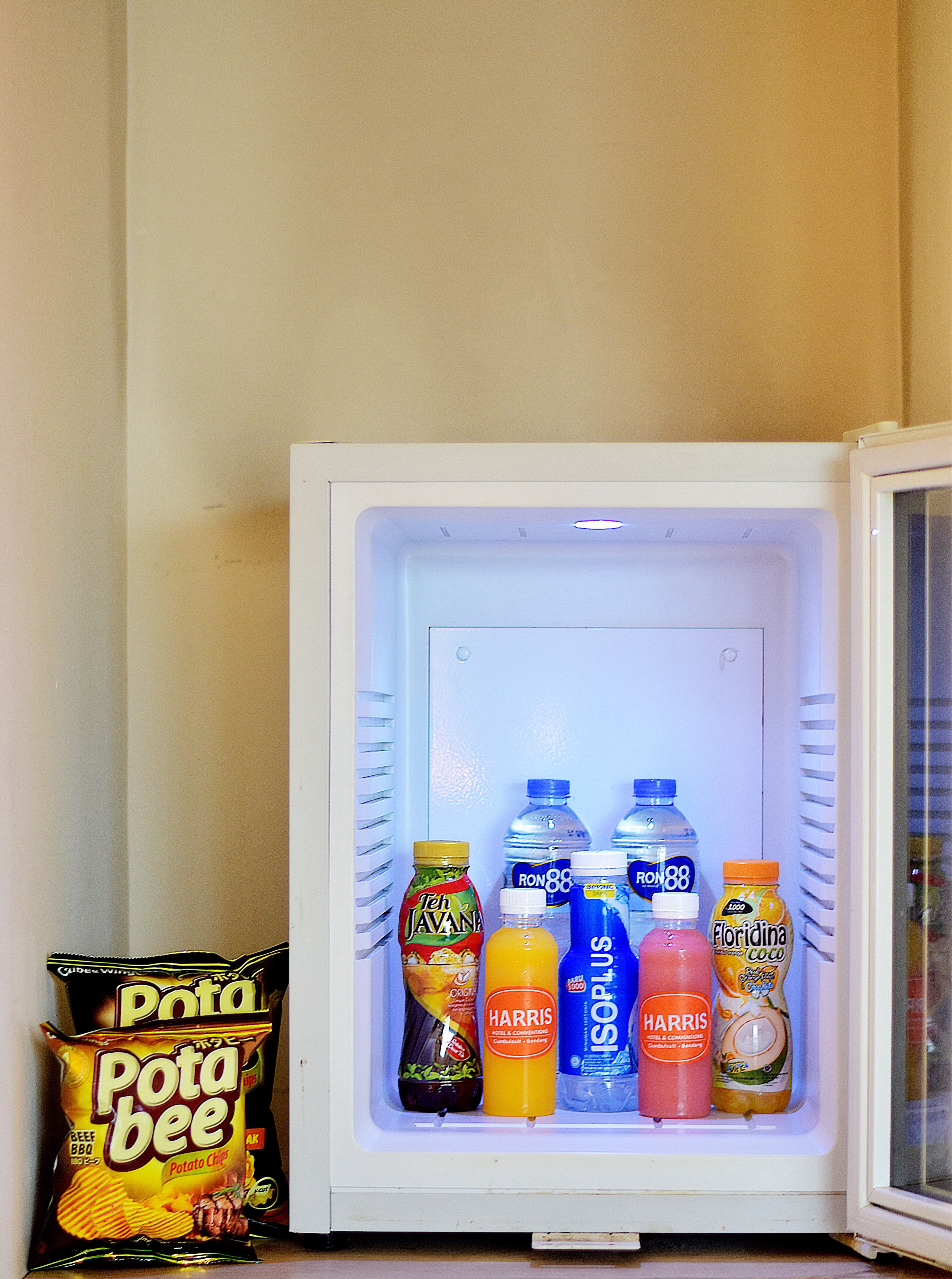 A refrigerator stocked with beverages and snacks.