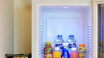 A refrigerator stocked with beverages and snacks.