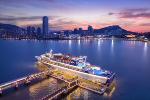 Experience the thrill of a luxurious ocean voyage from this majestic cruise ship, offering breathtaking views of the city skyline and surrounding mountains.