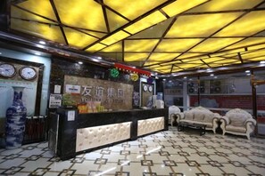 Un espace d’accueil comprenant un comptoir de réception, des horloges et un sol à motifs.