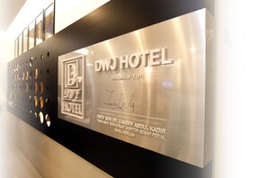 A plaque with the DWJ Hotel name and a signature, indicating a formal recognition or award. - DWJ Hotel (Ipoh)