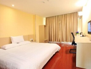 A hotel room with a bed, a desk, a chair, a television, and a curtain. - HanTing Hotel (Beijing New China International Exhibition Center) (Beijing)
