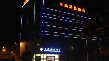 A hotel with illuminated signage and a prominent entrance.