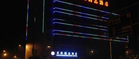 A hotel with illuminated signage and a prominent entrance.
