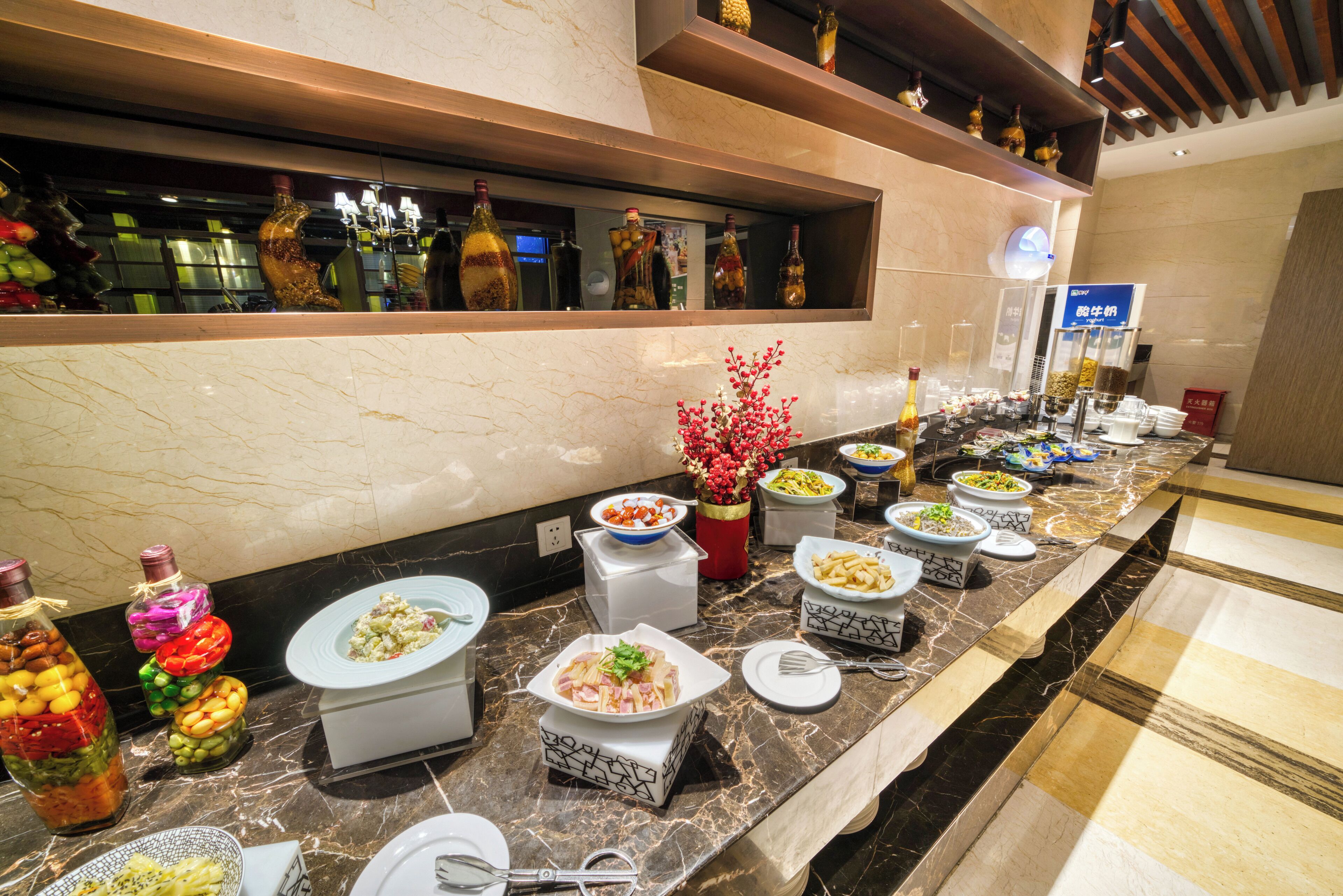 A buffet setup with various dishes and condiments.