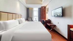 A hotel room with a large bed, a desk, a chair, and a television on the wall. - Gowin Hotel Hangzhou (Hangzhou)