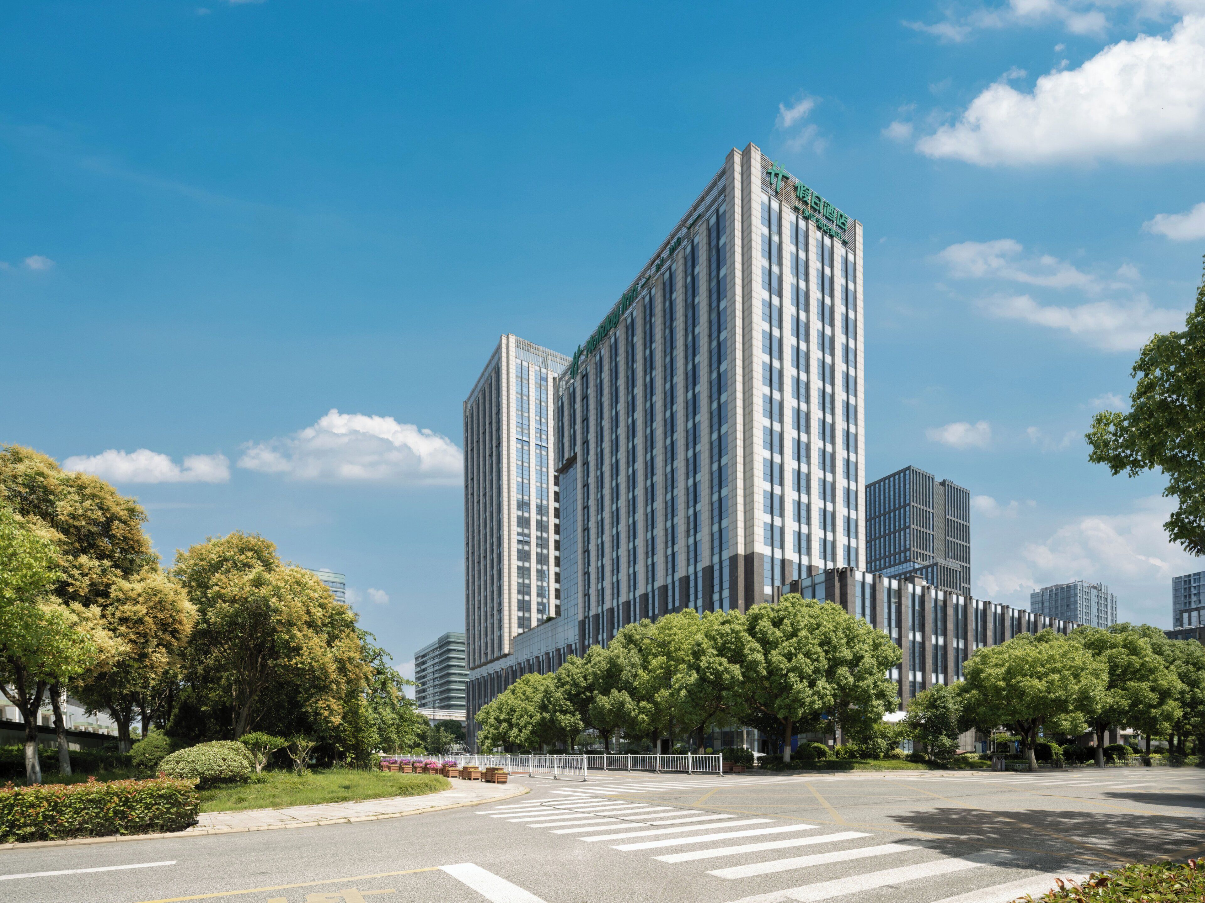 A modern high-rise building with a clear blue sky.
