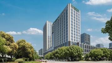 A modern high-rise building with a clear blue sky.