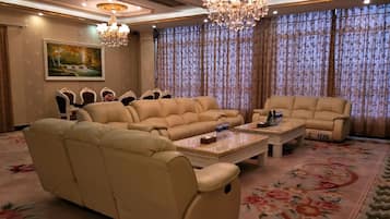 A spacious living room with a sectional sofa, a chaise lounge, and a coffee table.