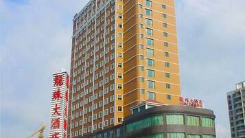 Un hotel de varios pisos con un letrero llamativo del hotel 'Lao Feng'.