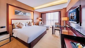 A hotel room with a large bed, a desk with a chair, a television, and a window with curtains. - Kunming Dingyi Hotel (Haiyuan Road Xicheng Times Square Branch) (Kunming)