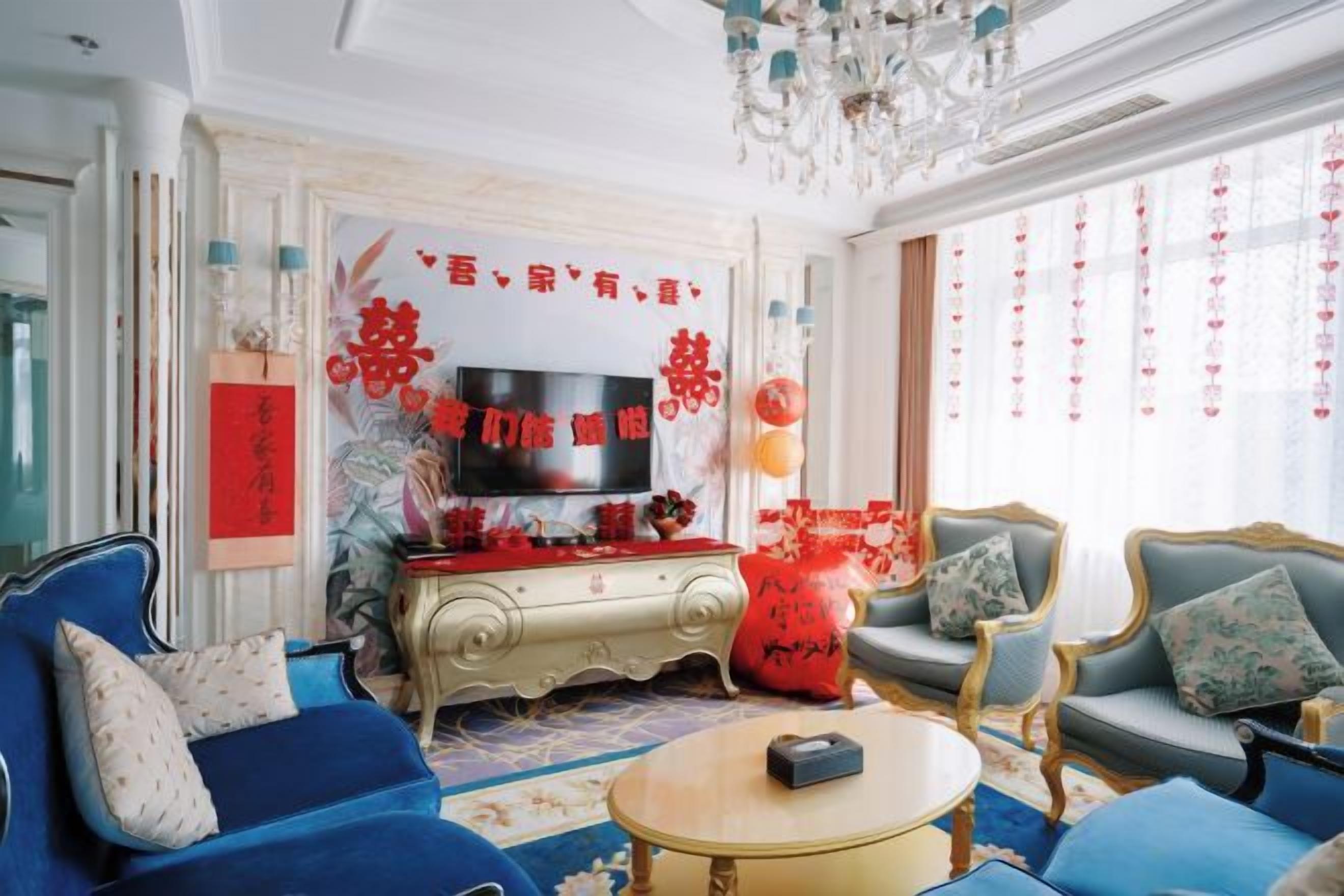 Una sala de estar tradicional con televisor, sofás y un decorativo mural.