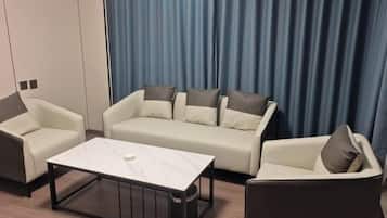 A modern living room with a sofa set, a coffee table, and a side table.